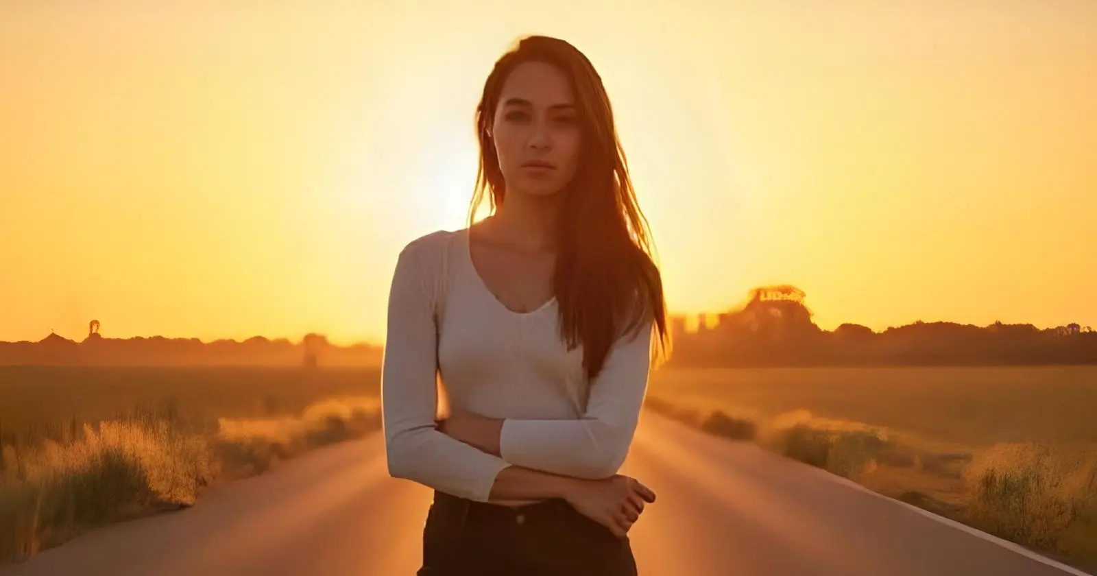 Confident French woman standing on a road at sunrise, facing the camera with calm determination &ndash; symbolic of facing challenges &ndash; faire face &agrave;